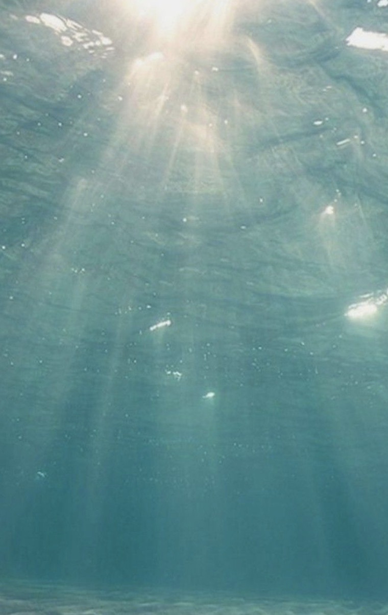 Sunlight filtering through calm turquoise ocean water