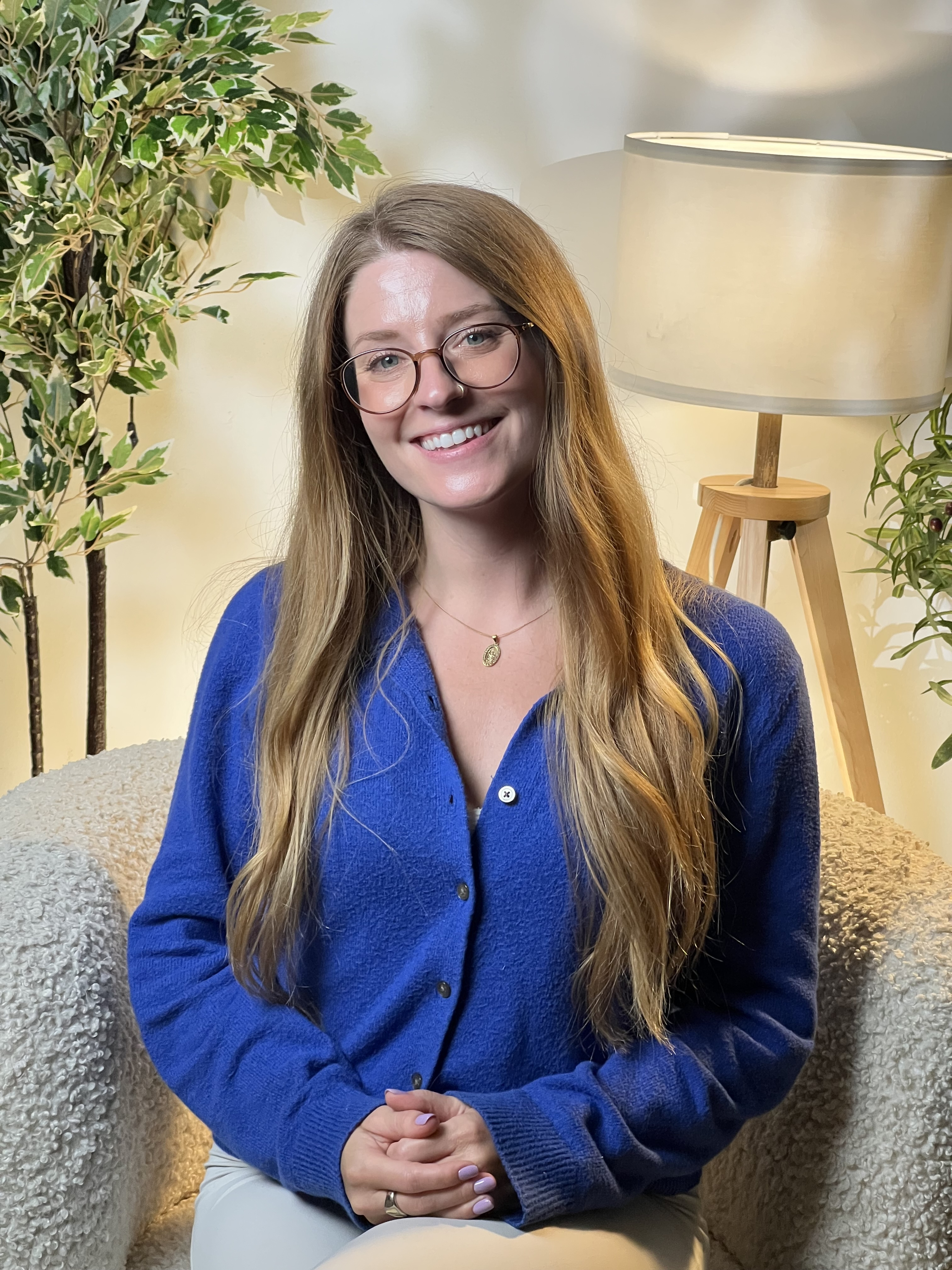 Sarah Joan Fox smiling in a therapy office